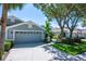 Inviting home exterior with a well-maintained front lawn and a two-car garage at 6044 Sandhill Ridge Dr, Lithia, FL 33547