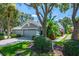 Charming single-story home with mature trees, a well-manicured lawn, and a two-car garage at 6044 Sandhill Ridge Dr, Lithia, FL 33547