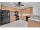 Well-equipped kitchen boasts ample counter space, wood cabinetry, and black appliances at 6044 Sandhill Ridge Dr, Lithia, FL 33547