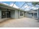 Expansive screened-in lanai with textured flooring and access to the home's interior at 6044 Sandhill Ridge Dr, Lithia, FL 33547