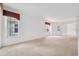 Spacious living room with neutral carpeting, white walls, and windows allowing ample natural light at 6044 Sandhill Ridge Dr, Lithia, FL 33547