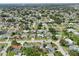 An aerial shot showcases the neighborhood's layout with its tree-lined streets and diverse housing at 6167 31St Ave, St Petersburg, FL 33710