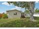Exterior view of the home with mature trees and beautiful landscaping in the backyard at 6167 31St Ave, St Petersburg, FL 33710