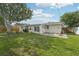 Spacious backyard features a patio area and mature trees, perfect for outdoor gatherings at 6167 31St Ave, St Petersburg, FL 33710