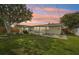 Enjoyable backyard with a well-maintained lawn, patio space, mature trees, and a privacy fence at 6167 31St Ave, St Petersburg, FL 33710