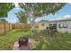Backyard with a large shade tree, a fire pit, and a patio set for outdoor enjoyment at 6167 31St Ave, St Petersburg, FL 33710