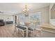 Inviting dining area showcasing wood floors, natural light, and modern chandelier at 6167 31St Ave, St Petersburg, FL 33710