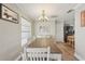 Open dining area with a large table, modern lighting, and seamless access to kitchen at 6167 31St Ave, St Petersburg, FL 33710
