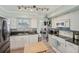 Charming kitchen with white cabinetry, granite counters, mosaic backsplash, and modern appliances at 6167 31St Ave, St Petersburg, FL 33710