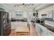 Stylish kitchen featuring white cabinets, granite counters, mosaic backsplash and stainless steel refrigerator at 6167 31St Ave, St Petersburg, FL 33710