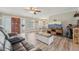 Inviting living room showcasing wood floors, an open layout, and views of the dining area at 6167 31St Ave, St Petersburg, FL 33710