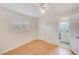 Cozy bedroom with light wood floors, a window with shutters, a closet, and a peek into the bathroom at 6237 50Th N Ave, St Petersburg, FL 33709