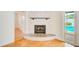 Living room fireplace with tile surround and wood mantle with view of backyard pool at 6237 50Th N Ave, St Petersburg, FL 33709
