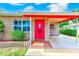 Inviting front entrance with a bright red door, brick accents, and a covered carport at 6237 50Th N Ave, St Petersburg, FL 33709