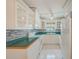 Bright kitchen featuring white cabinets, tiled backsplash, and modern appliances at 6237 50Th N Ave, St Petersburg, FL 33709