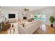 Modern living room with fireplace, hardwood floors, and sliding doors to the pool area at 6237 50Th N Ave, St Petersburg, FL 33709