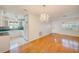 Open-concept living space with hardwood floors, chandelier, and a view of the kitchen at 6237 50Th N Ave, St Petersburg, FL 33709