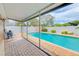 Relaxing covered patio with a view of the sparkling in-ground pool and well-maintained yard at 6237 50Th N Ave, St Petersburg, FL 33709