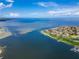 An aerial view highlights a coastal community with waterfront access and clear blue skies and water at 6334 Cocoa Ln, Apollo Beach, FL 33572
