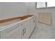White vanity with marble-look floors in a remodeled bathroom at 6334 Cocoa Ln, Apollo Beach, FL 33572