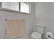 Close up of a toilet and towel in the renovated bathroom at 6334 Cocoa Ln, Apollo Beach, FL 33572