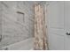 Renovated bathroom featuring a bathtub and shower with marble-look tile at 6334 Cocoa Ln, Apollo Beach, FL 33572