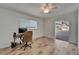 Inviting bedroom featuring ceiling fan, desk space, and direct access to outdoor patio at 6334 Cocoa Ln, Apollo Beach, FL 33572