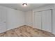 View of bedroom with closet, wood-look floors and neutral paint at 6334 Cocoa Ln, Apollo Beach, FL 33572