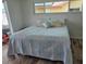 Comfortable bedroom featuring a cozy bed, wood-look floors, and bright natural light at 6334 Cocoa Ln, Apollo Beach, FL 33572