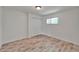 Well-lit bedroom featuring wood-look floors and a closet with bi-fold doors at 6334 Cocoa Ln, Apollo Beach, FL 33572