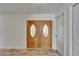 Interior view of the double front doors and hardwood floors of the foyer at 6334 Cocoa Ln, Apollo Beach, FL 33572