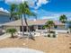 Charming single-story home with a well-maintained front yard, stone walkway, landscaping and pink accents at 6334 Cocoa Ln, Apollo Beach, FL 33572