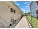 Side view of home exterior, showing walkway and well maintained landscaping at 6334 Cocoa Ln, Apollo Beach, FL 33572