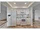 Modern kitchen featuring all white appliances and a granite countertop breakfast bar at 6334 Cocoa Ln, Apollo Beach, FL 33572