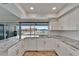 Kitchen featuring granite countertops, white cabinets, and a view of the water from the sink at 6334 Cocoa Ln, Apollo Beach, FL 33572