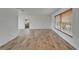 Open living room features a window, light wood flooring and neutral walls at 6334 Cocoa Ln, Apollo Beach, FL 33572