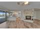 Inviting living room featuring a stone fireplace and seamless access to a modern kitchen with granite countertops at 6334 Cocoa Ln, Apollo Beach, FL 33572