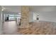 Spacious living room featuring light wood flooring, a stone fireplace and water views at 6334 Cocoa Ln, Apollo Beach, FL 33572