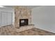 Cozy living room showcasing a stone fireplace, light wood flooring, and closet at 6334 Cocoa Ln, Apollo Beach, FL 33572