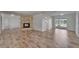 Open-concept living room boasting light wood flooring, stone fireplace and water views at 6334 Cocoa Ln, Apollo Beach, FL 33572
