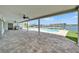 Expansive brick patio with a pool, outdoor grill, and waterfront views at 6334 Cocoa Ln, Apollo Beach, FL 33572