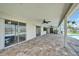 Large covered patio area with ceiling fans, overlooking the pool and canal at 6334 Cocoa Ln, Apollo Beach, FL 33572