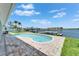 Backyard features a kidney-shaped pool, brick patio, and waterfront views with a private dock and boat lift at 6334 Cocoa Ln, Apollo Beach, FL 33572