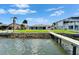 Back of waterfront home featuring a private dock and beautiful lawn at 6334 Cocoa Ln, Apollo Beach, FL 33572