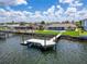 Beautiful waterfront home with a private dock, pool, and lush green lawn at 6334 Cocoa Ln, Apollo Beach, FL 33572