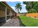 Backyard showcasing a manicured lawn, framed by a privacy fence, and a screened patio for relaxing and entertaining at 6530 68Th N St, Pinellas Park, FL 33781