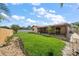 Large backyard features lush grass, privacy fencing, and a covered patio, offering an ideal setting for outdoor activities and relaxation at 6530 68Th N St, Pinellas Park, FL 33781