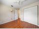 Bedroom features wood floors, a large closet, ceiling fan and a lamp at 6530 68Th N St, Pinellas Park, FL 33781