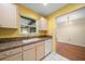 Bright kitchen with white cabinets, a window, and durable countertops; perfect for cooking and entertaining with ease at 6530 68Th N St, Pinellas Park, FL 33781