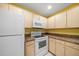Functional kitchen featuring classic white appliances, plenty of wooden cabinets, and durable countertops for meal preparation at 6530 68Th N St, Pinellas Park, FL 33781